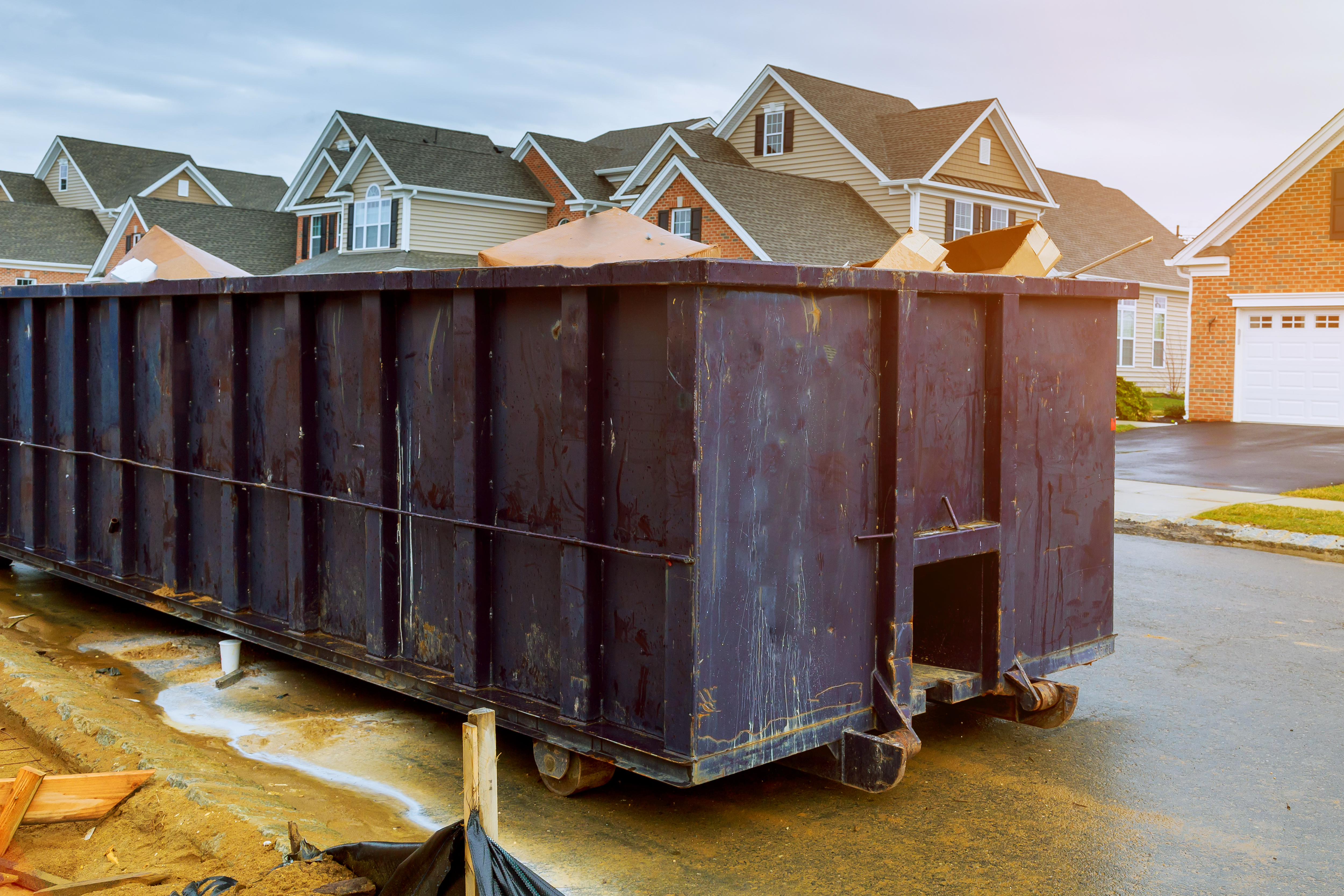 garbage containers near the new home, Red containers, recycling and waste construction site on the background; Shutterstock ID 1060674794; purchase_order: Limited 4/15; job: ; client: ; other: